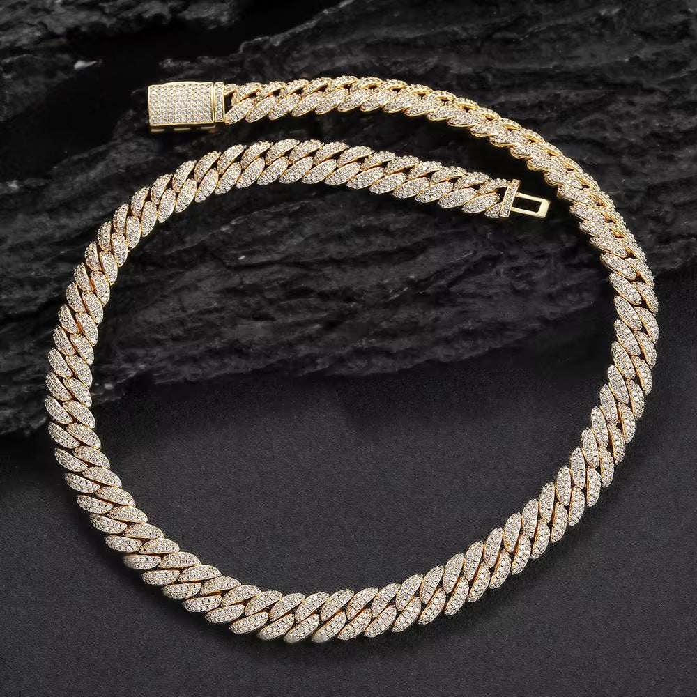 Gold braided necklace on a dark textured background
