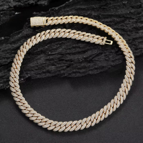 Gold braided necklace on a dark textured background
