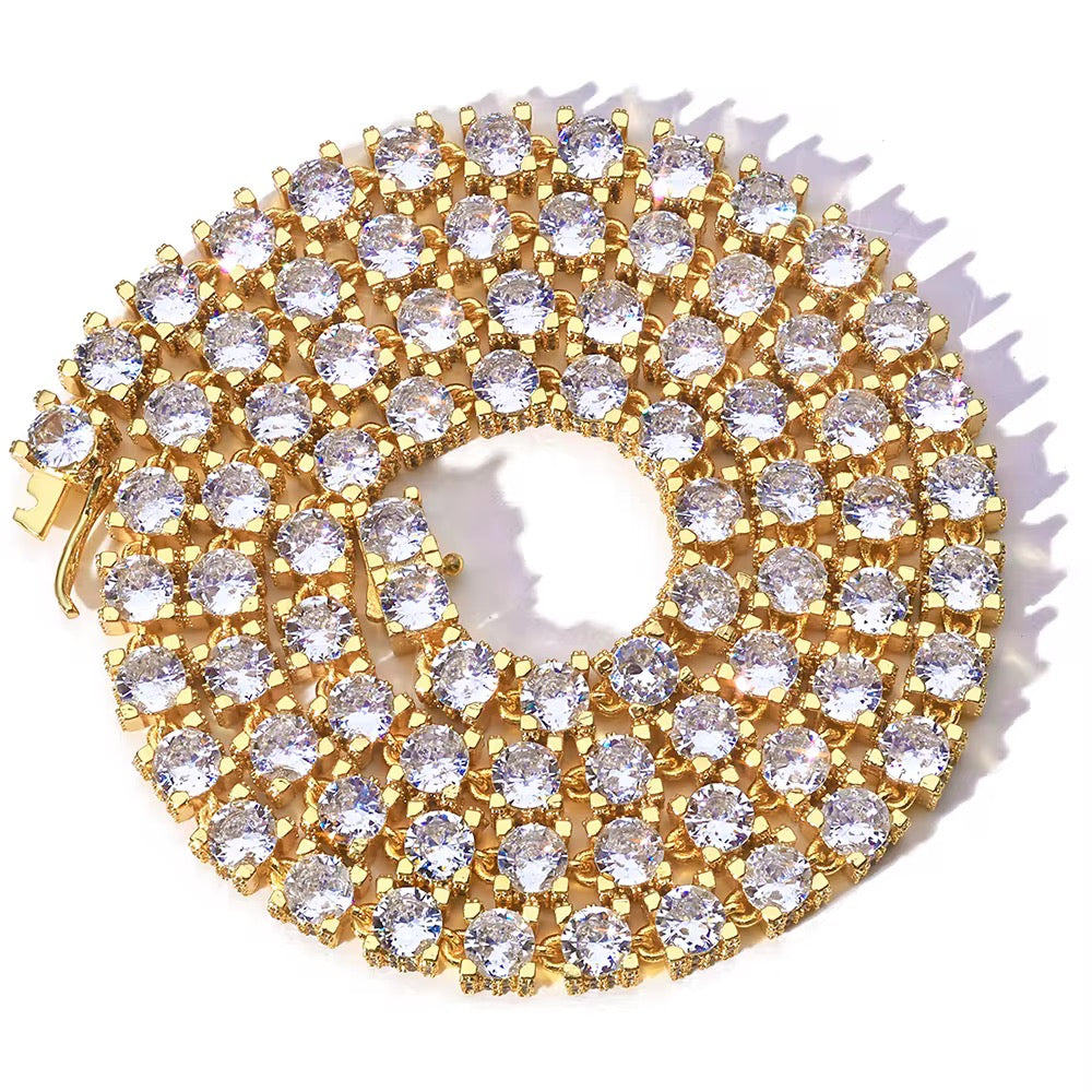 Gold brooch with clear gemstones on a white background

