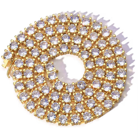 Gold brooch with clear gemstones on a white background


