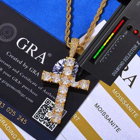 Gold cross pendant with diamonds on a blue and black background with GRA branding.