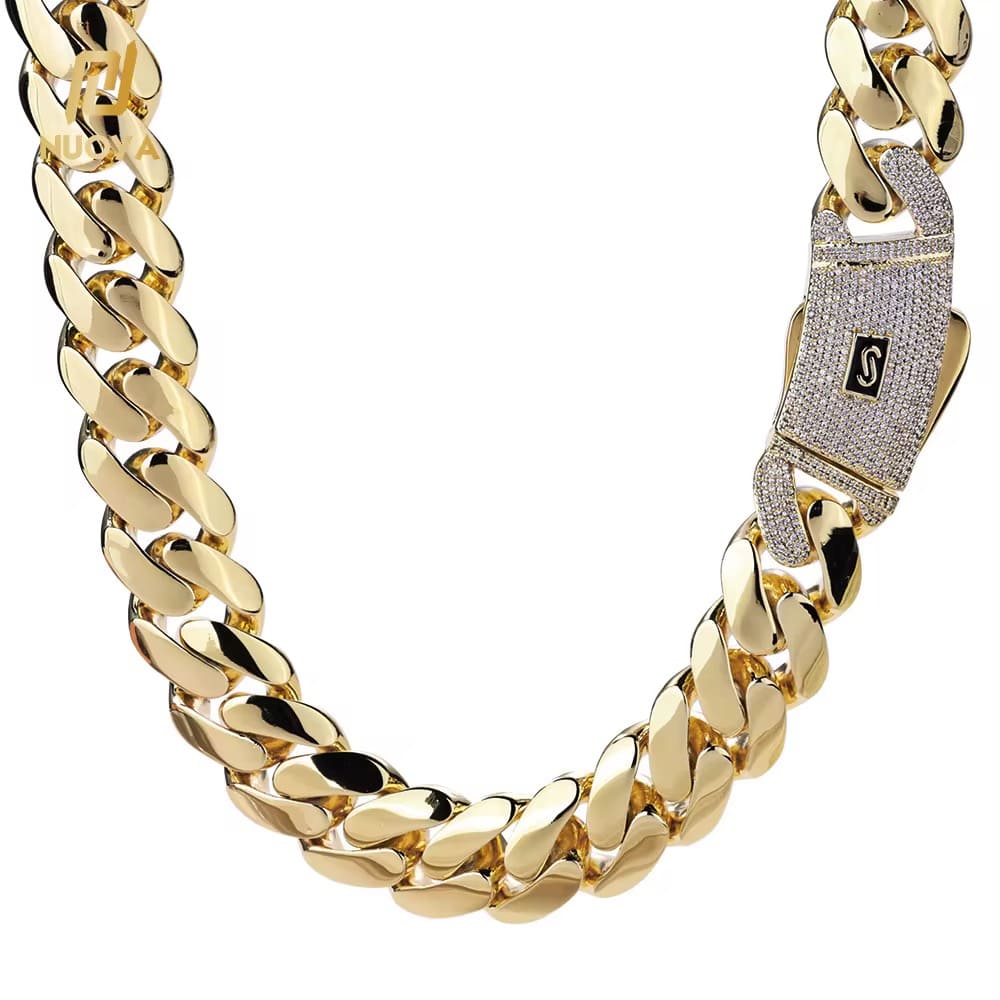 Gold chain necklace with a diamond-encrusted clasp on a white background

