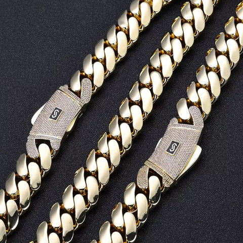 Gold chain with diamond-encrusted clasp on a dark background


