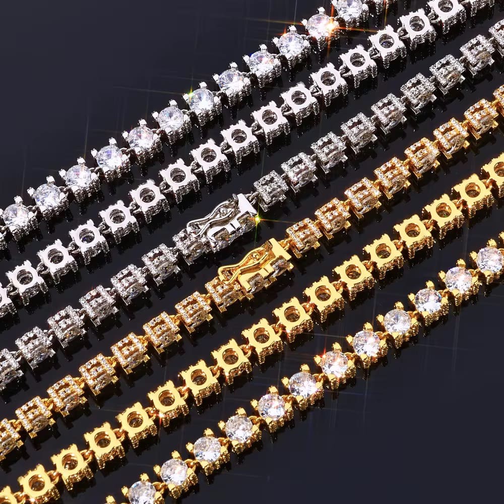 Three diamond-encrusted bracelets in gold, silver, and white on a dark background

