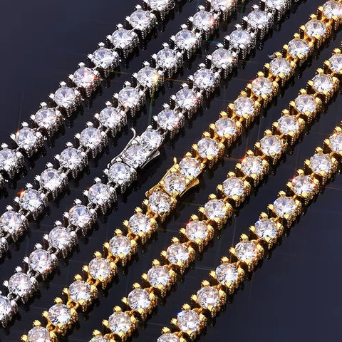 Diamond-encrusted bracelets, one gold and one silver, on a dark background.

