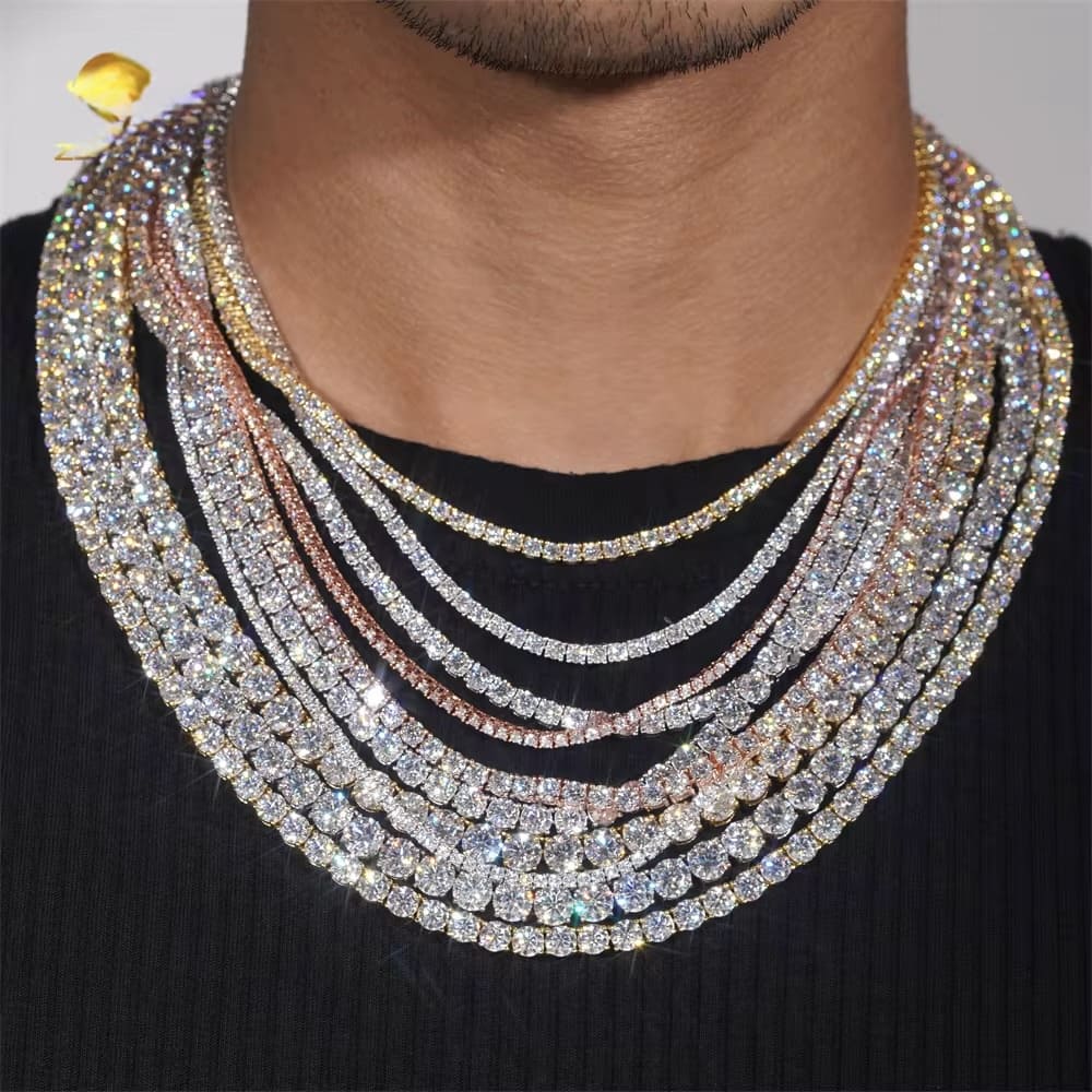 Multiple diamond necklaces stacked on a person's neck against a neutral background