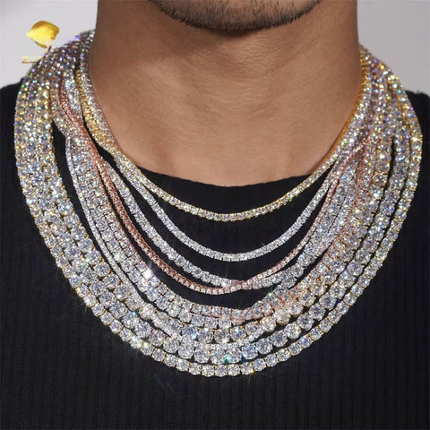 Multiple diamond necklaces stacked on a person's neck against a neutral background