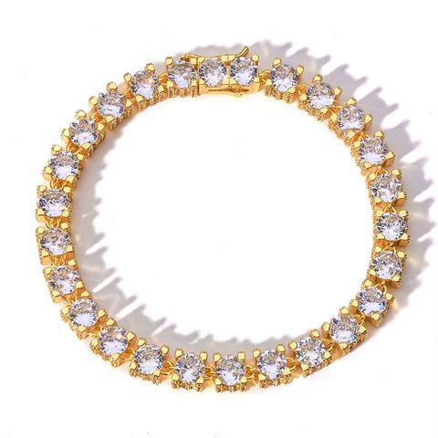 Gold ring with clear gemstones on a white background