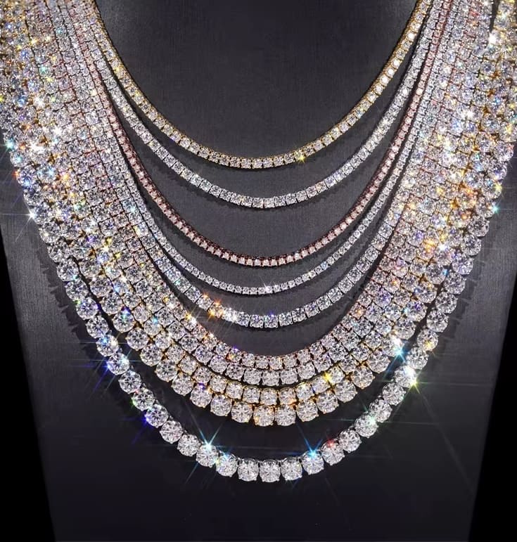 Multiple layers of sparkling diamond necklaces on a dark background