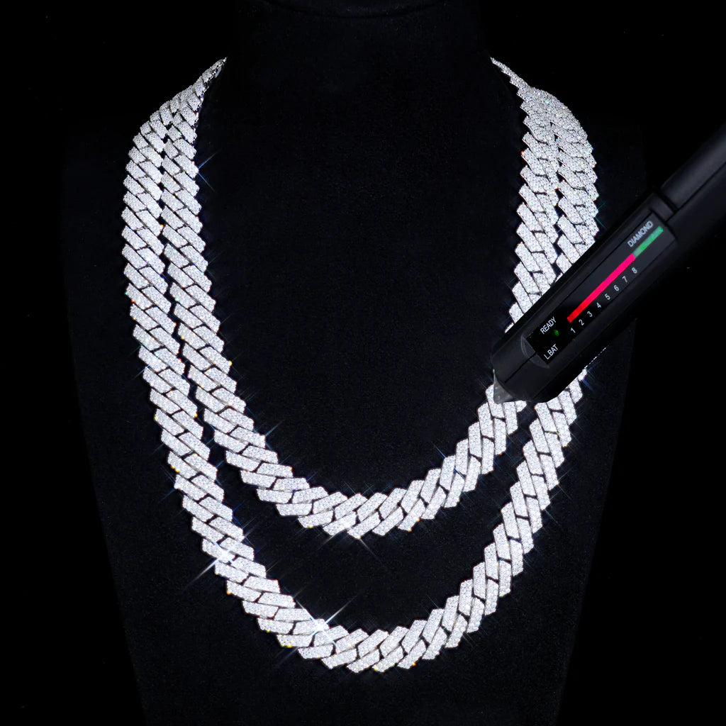 Silver chain necklace on a black background with a digital scale.

