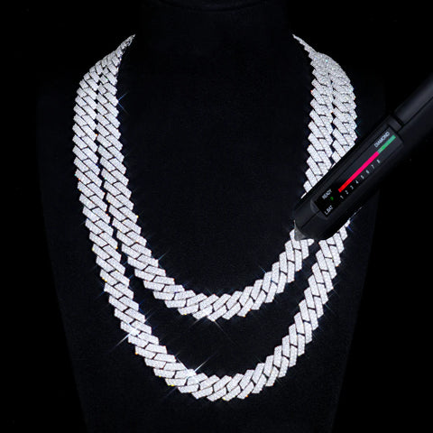 Silver chain necklace on a black background with a digital scale.

