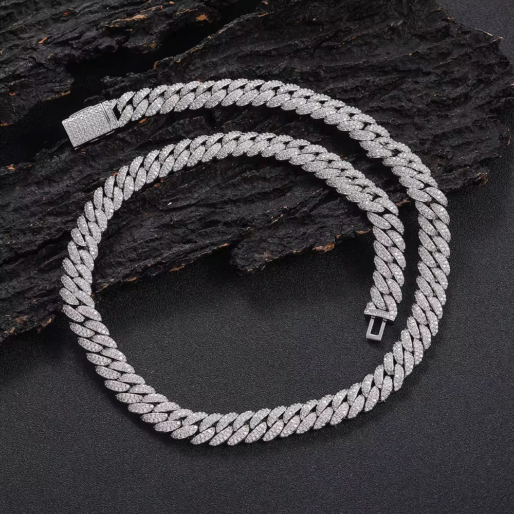 Silver chain necklace on a dark textured surface

