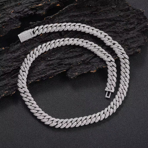Silver chain necklace on a dark textured surface

