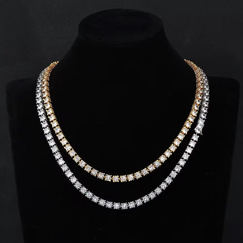 Two diamond necklaces on a black mannequin bust against a dark background

